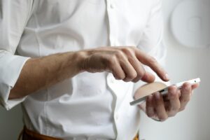 Hand scrolling a social feed on a smartphone